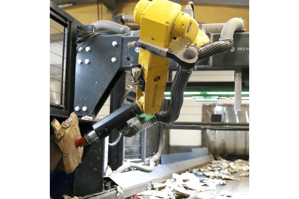 Automated robot operating machinery in a factory.